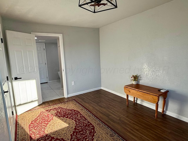 interior space featuring baseboards and wood finished floors