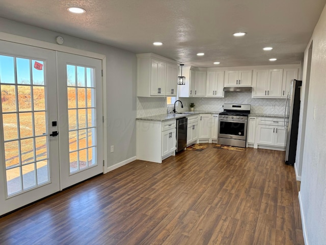 kitchen with under cabinet range hood, stainless steel appliances, white cabinets, french doors, and decorative light fixtures