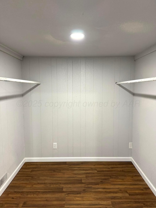 walk in closet featuring visible vents and dark wood finished floors