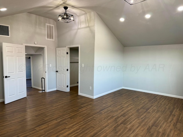 interior space with baseboards, dark wood-style flooring, visible vents, and an inviting chandelier