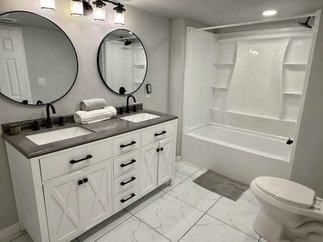 full bath featuring marble finish floor, a sink, shower / bathing tub combination, and double vanity