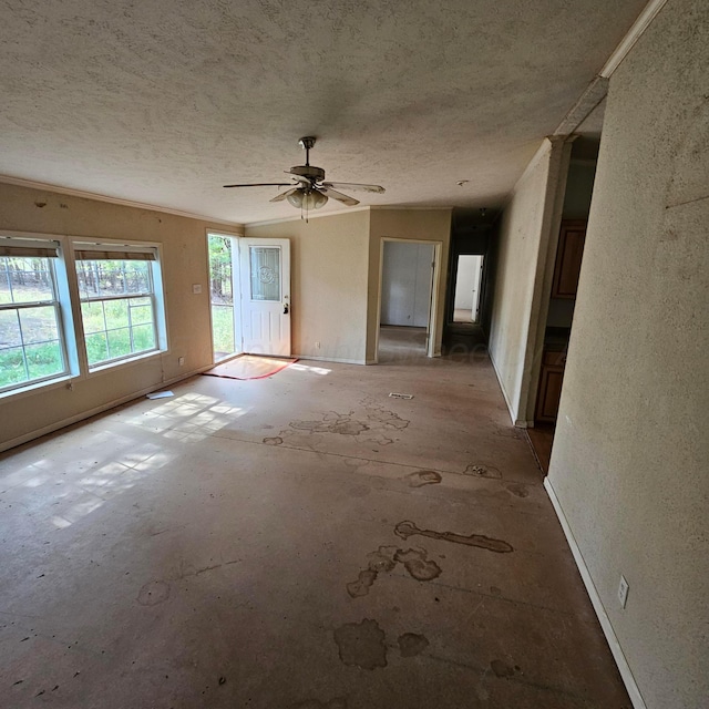 unfurnished room with ceiling fan and a textured ceiling