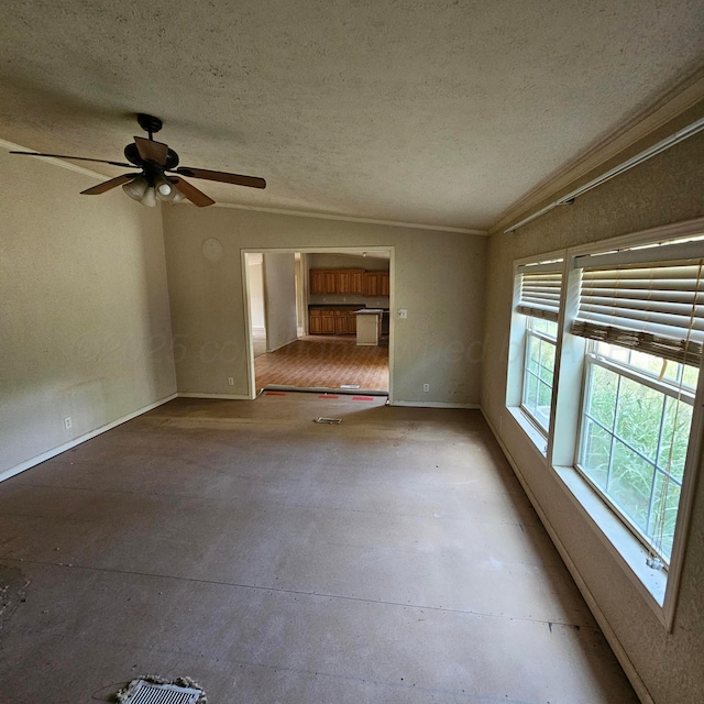 unfurnished room featuring plenty of natural light, ceiling fan, and a textured ceiling