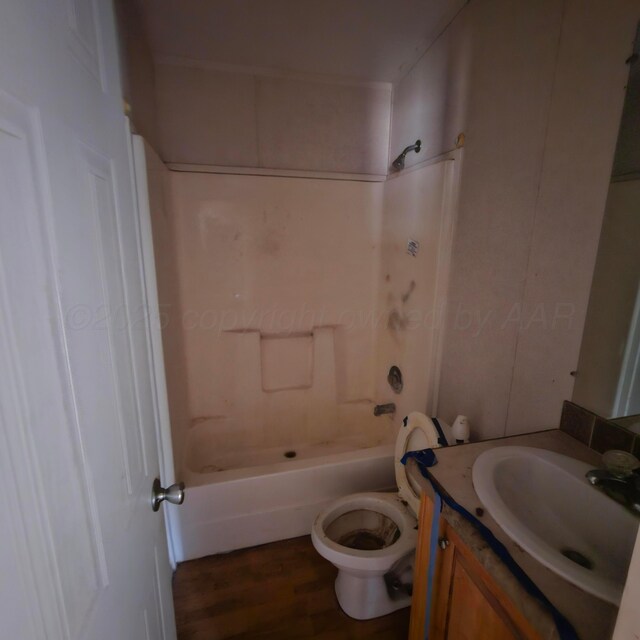 full bathroom with shower / tub combination, vanity, wood-type flooring, and toilet