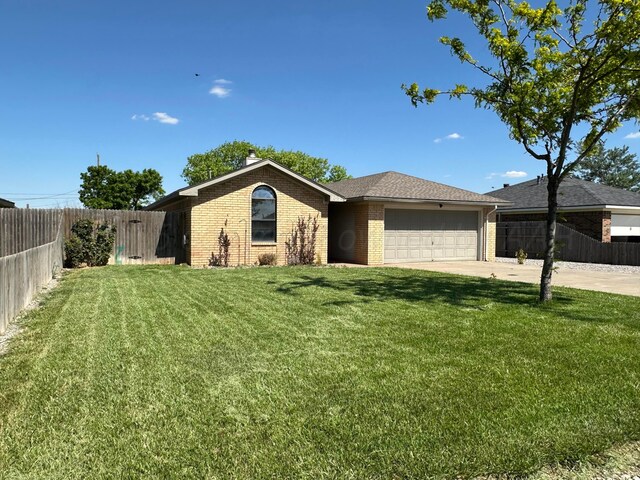 702 Floyd Ave, Dumas, TX 79029 - ranch-style home featuring brick siding, a garage, and driveway