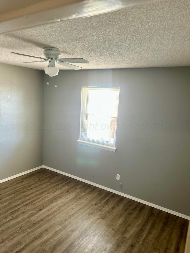 702 Floyd Ave, Dumas, TX 79029 - empty room featuring dark wood-style flooring, a textured ceiling, baseboards, and ceiling fan