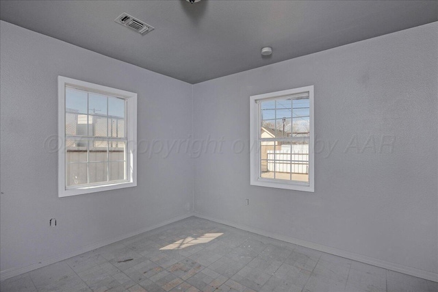 507 N Taylor St, Amarillo, TX 79107 - empty room with plenty of natural light, tile patterned floors, and a smoke detector