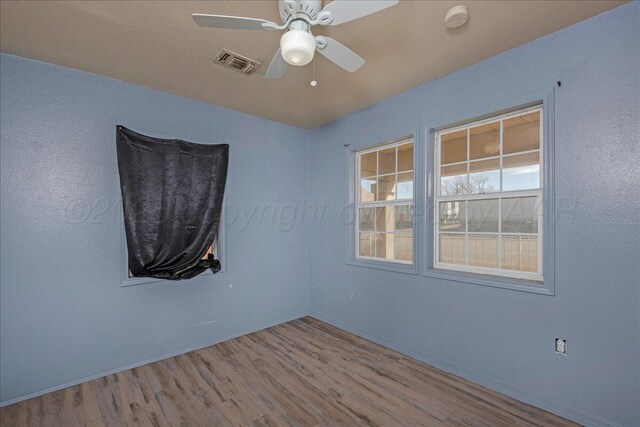 507 N Taylor St, Amarillo, TX 79107 - empty room featuring wood finished floors, a ceiling fan, and a smoke detector