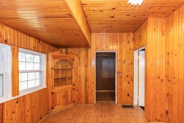 1600 S Hughes St, Amarillo, TX 79102 - corridor featuring wood walls, brick patterned flooring, and wood ceiling