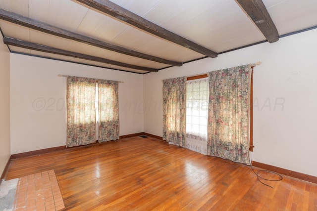 1600 S Hughes St, Amarillo, TX 79102 - unfurnished room with healthy amount of natural light, beam ceiling, baseboards, and wood finished floors