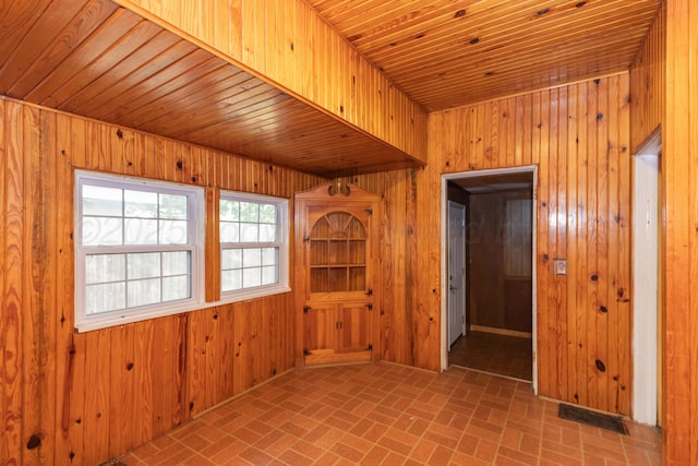 1600 S Hughes St, Amarillo, TX 79102 - unfurnished room with brick patterned flooring, wood walls, and wooden ceiling