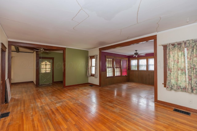 1600 S Hughes St, Amarillo, TX 79102 - unfurnished living room featuring a ceiling fan, wood finished floors, baseboards, and crown molding
