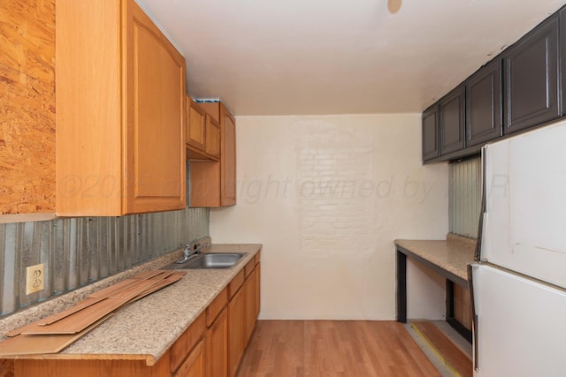 1600 S Hughes St, Amarillo, TX 79102 - kitchen with a sink, freestanding refrigerator, light wood-type flooring, and light countertops