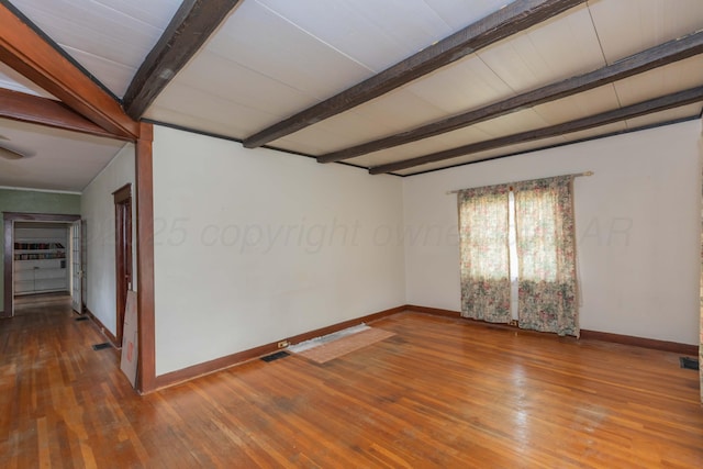 1600 S Hughes St, Amarillo, TX 79102 - empty room with baseboards, beamed ceiling, and wood-type flooring