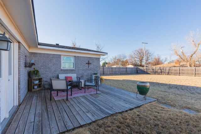 wooden terrace with outdoor lounge area and a fenced backyard