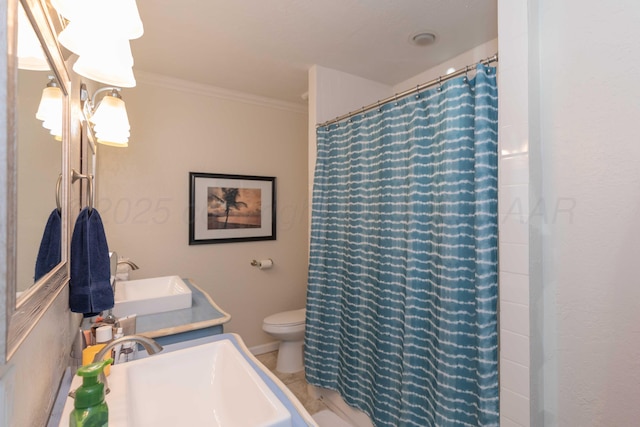 full bath with toilet, curtained shower, crown molding, and a sink