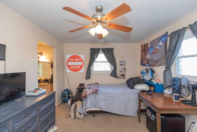 bedroom with light carpet and a ceiling fan