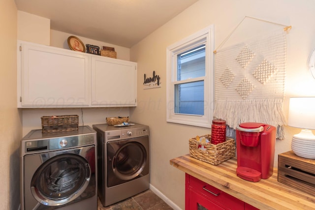 laundry area with cabinet space, baseboards, and separate washer and dryer