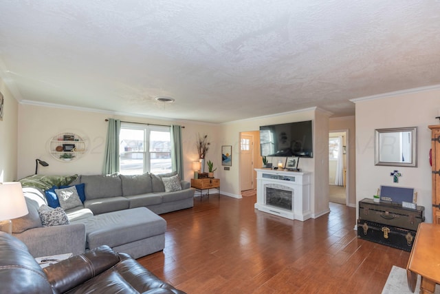 living area with a fireplace, crown molding, a textured ceiling, wood finished floors, and baseboards