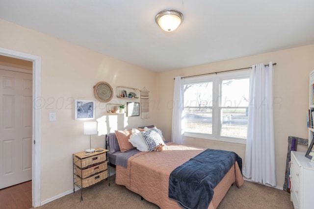 bedroom with carpet and baseboards