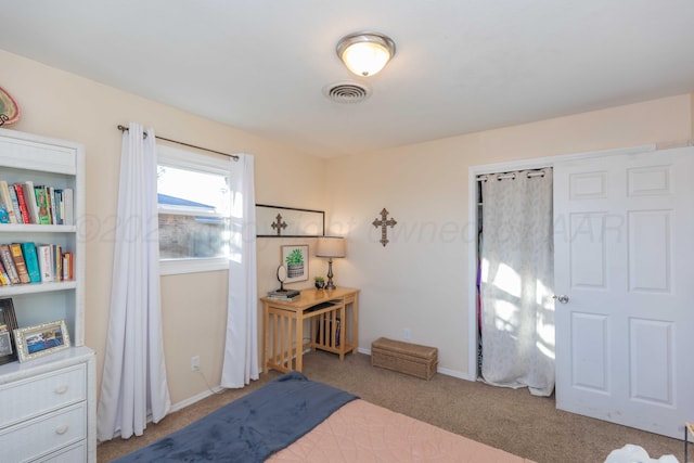 carpeted bedroom featuring baseboards and visible vents