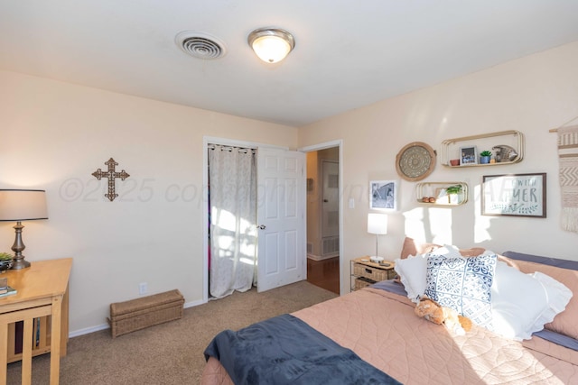 carpeted bedroom featuring baseboards and visible vents