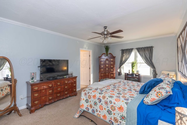 carpeted bedroom featuring baseboards, ornamental molding, and ceiling fan