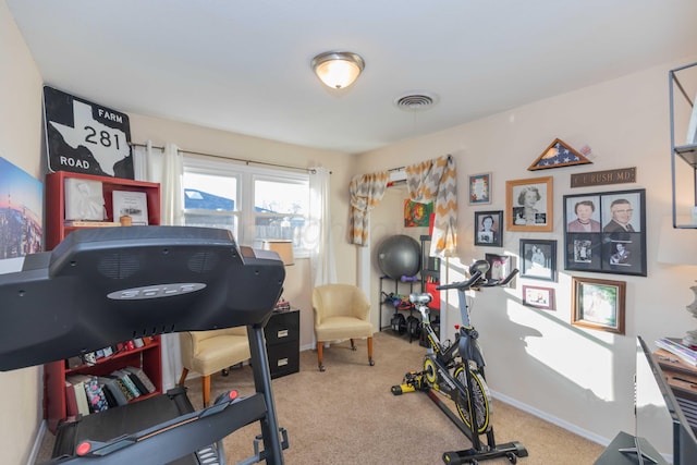 workout area with baseboards, visible vents, and carpet flooring