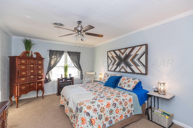 bedroom with crown molding, visible vents, a ceiling fan, carpet flooring, and baseboards