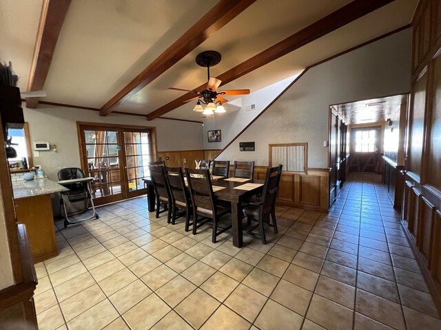 151 Killingsworth Ave, Booker, TX 79005 - dining space featuring light tile patterned floors, lofted ceiling with beams, a ceiling fan, visible vents, and wainscoting