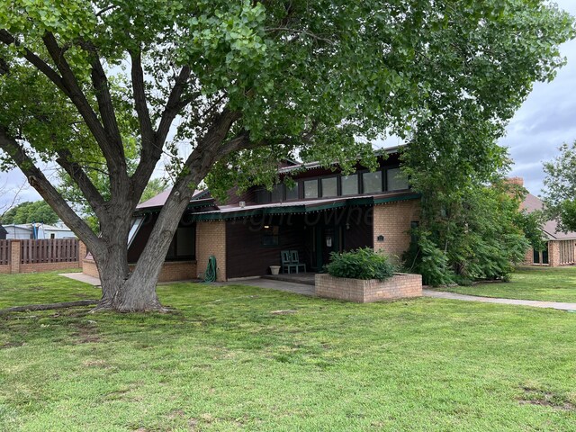 151 Killingsworth Ave, Booker, TX 79005 - rear view of house featuring brick siding and a patio area