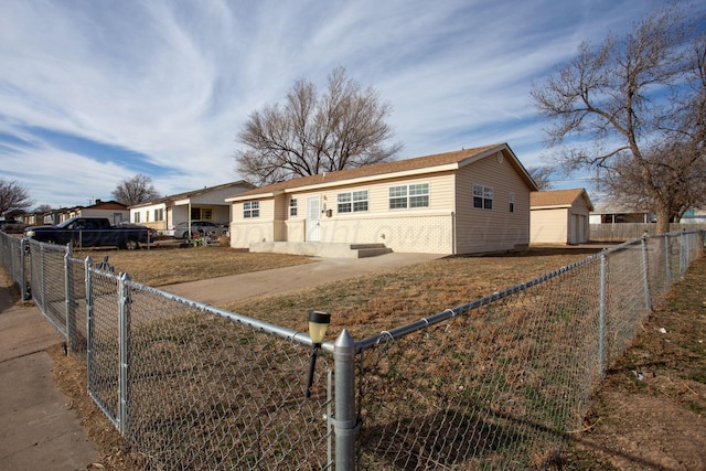 ranch-style house featuring a fenced front yard and brick siding