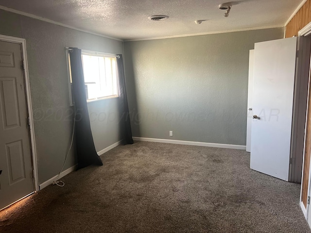 104 Peiffer St, Borger, TX 79007 - spare room with a textured ceiling, ornamental molding, visible vents, and carpet