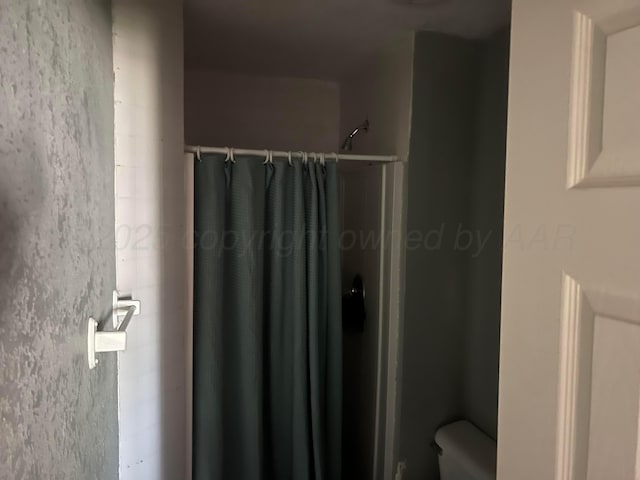 104 Peiffer St, Borger, TX 79007 - bathroom featuring toilet and a stall shower