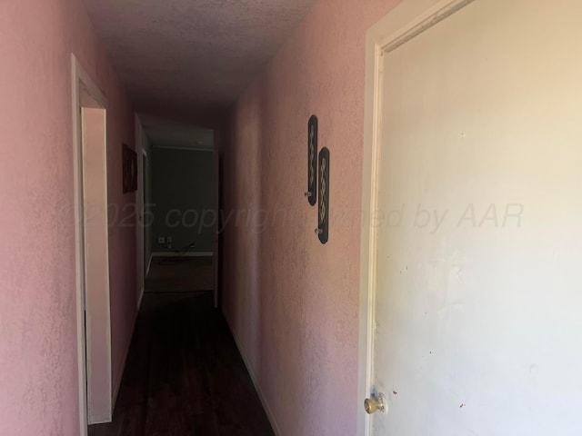 104 Peiffer St, Borger, TX 79007 - corridor featuring dark wood-style floors and a textured wall