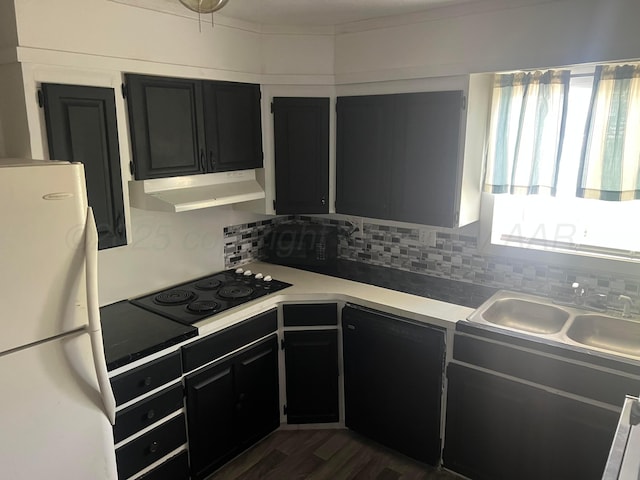 104 Peiffer St, Borger, TX 79007 - kitchen with freestanding refrigerator, black electric cooktop, dark cabinets, and under cabinet range hood