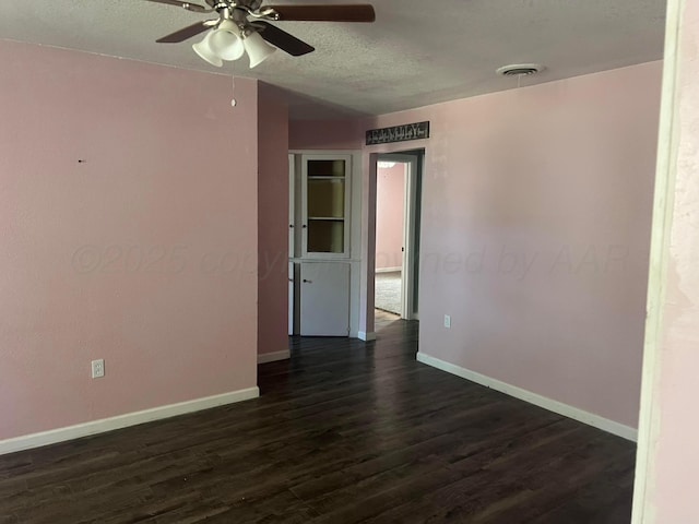 104 Peiffer St, Borger, TX 79007 - unfurnished room with baseboards, a textured ceiling, ceiling fan, and dark wood-style floors
