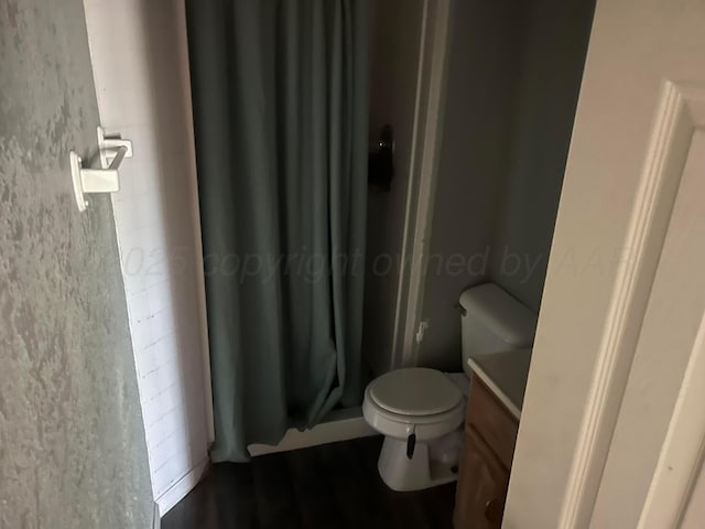 104 Peiffer St, Borger, TX 79007 - full bath featuring vanity, toilet, a shower with curtain, and wood finished floors