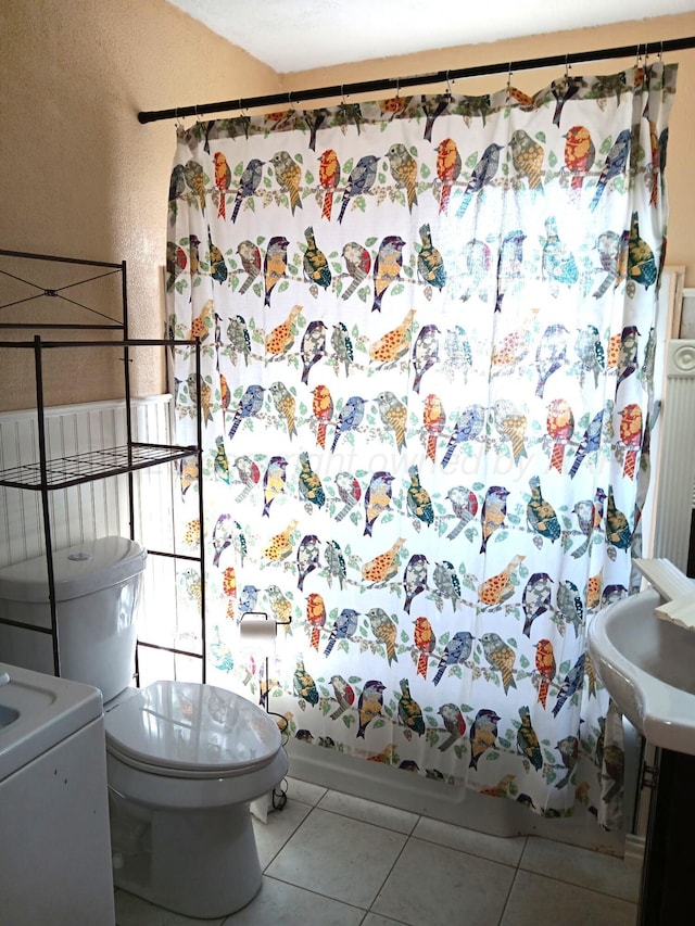 full bathroom with tile patterned flooring, shower / bathtub combination with curtain, and toilet