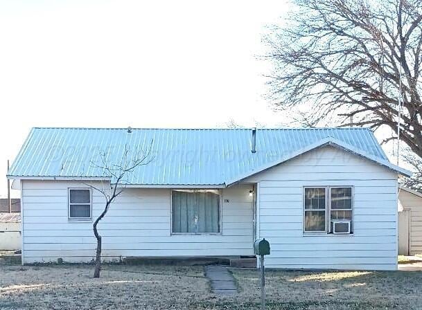 back of house featuring metal roof