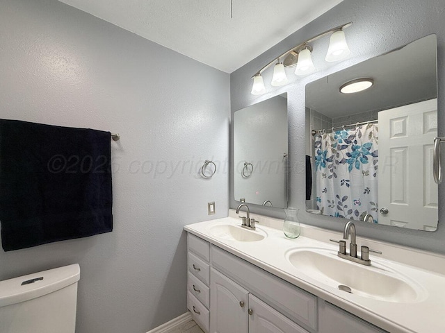 1301 Clyde St, Amarillo, TX 79106 - full bathroom with double vanity, a textured wall, and curtained shower