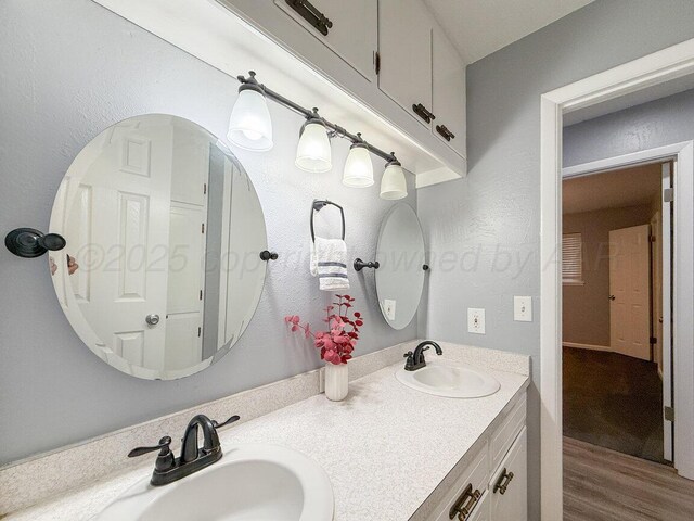 1301 Clyde St, Amarillo, TX 79106 - full bathroom with double vanity and wood finished floors