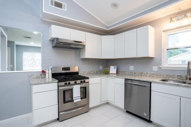 1301 Clyde St, Amarillo, TX 79106 - kitchen with stainless steel appliances, extractor fan, white cabinets, vaulted ceiling, and light stone countertops