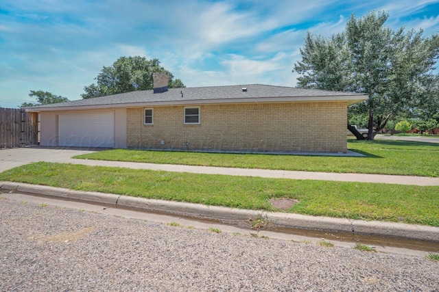 1301 Clyde St, Amarillo, TX 79106 - view of home's exterior with brick siding, driveway, an attached garage, and a chimney
