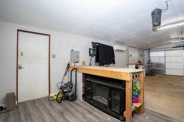 1301 Clyde St, Amarillo, TX 79106 - garage featuring a wall mounted AC, a workshop area, and a garage door opener