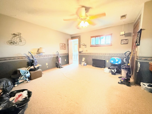 interior space featuring carpet and ceiling fan