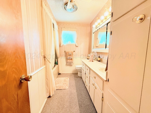 full bathroom featuring vanity, toilet, a textured ceiling, and bathtub / shower combination