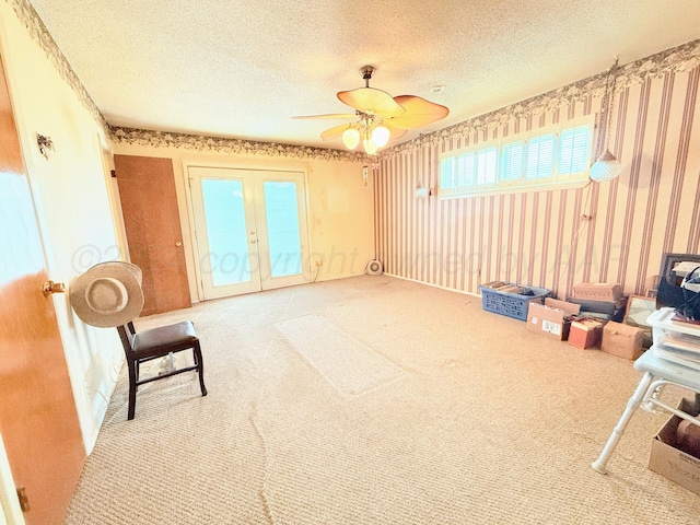 interior space featuring light carpet, french doors, a textured ceiling, and ceiling fan