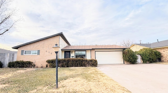 ranch-style home featuring a garage and a front yard