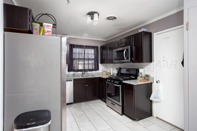 kitchen with sink, decorative backsplash, dark brown cabinets, appliances with stainless steel finishes, and ornamental molding